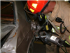 A firefighter working with a car